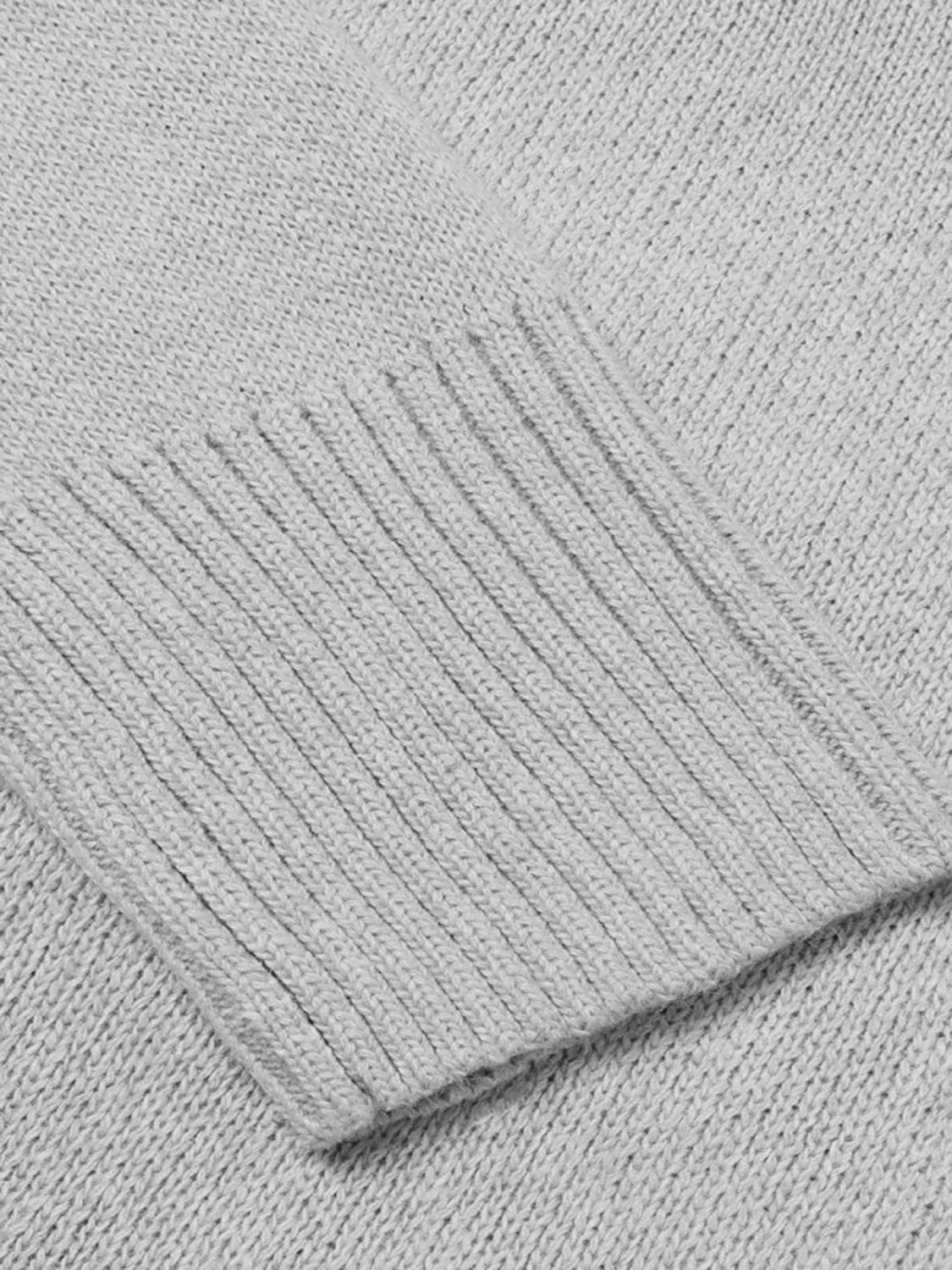 Light grey knit sweater with ribbed trim detail on the cuff.