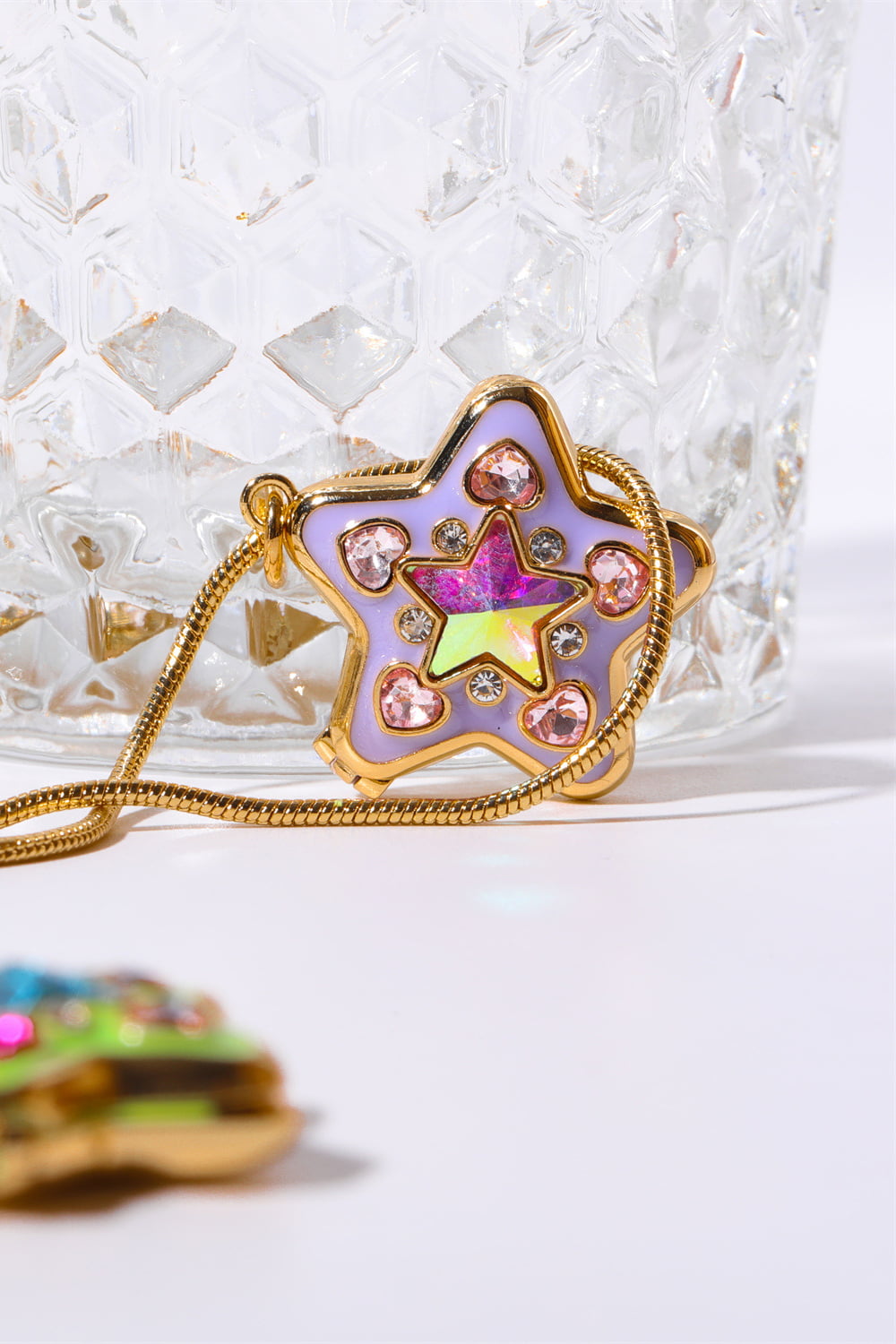Lavender starburst pendant necklace with pink heart and clear gems on gold chain