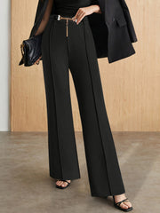 Black flared leg trousers with chain detail belt and front seams