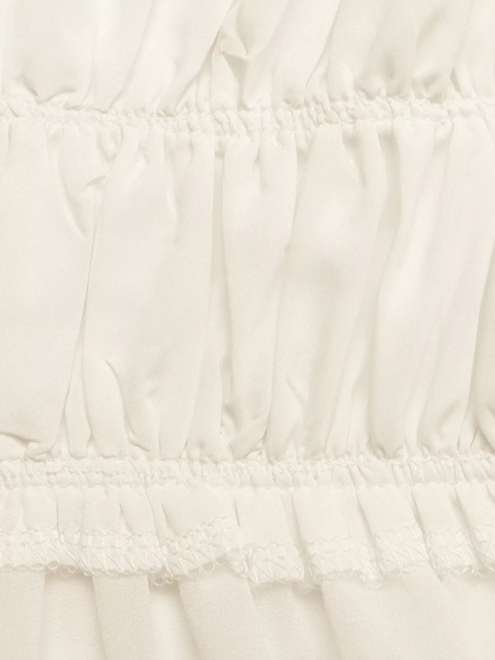 Gathered neckline peplum cami top in white with ruffled hem detail