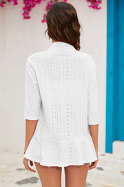 White perforated ruffle hem cardigan with 3/4 sleeves and eyelet details.