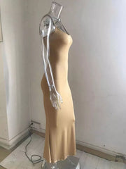Camel spaghetti strap bodycon maxi dress with a flared hem.
