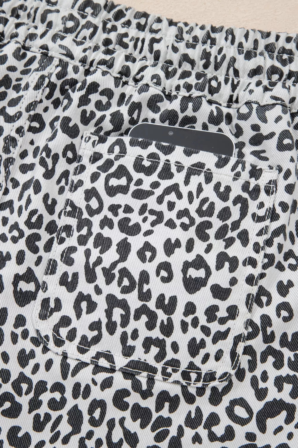 Leopard print denim skort with pockets and elastic waistband.