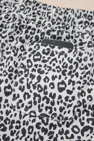 Leopard print denim skort with pockets and elastic waistband.