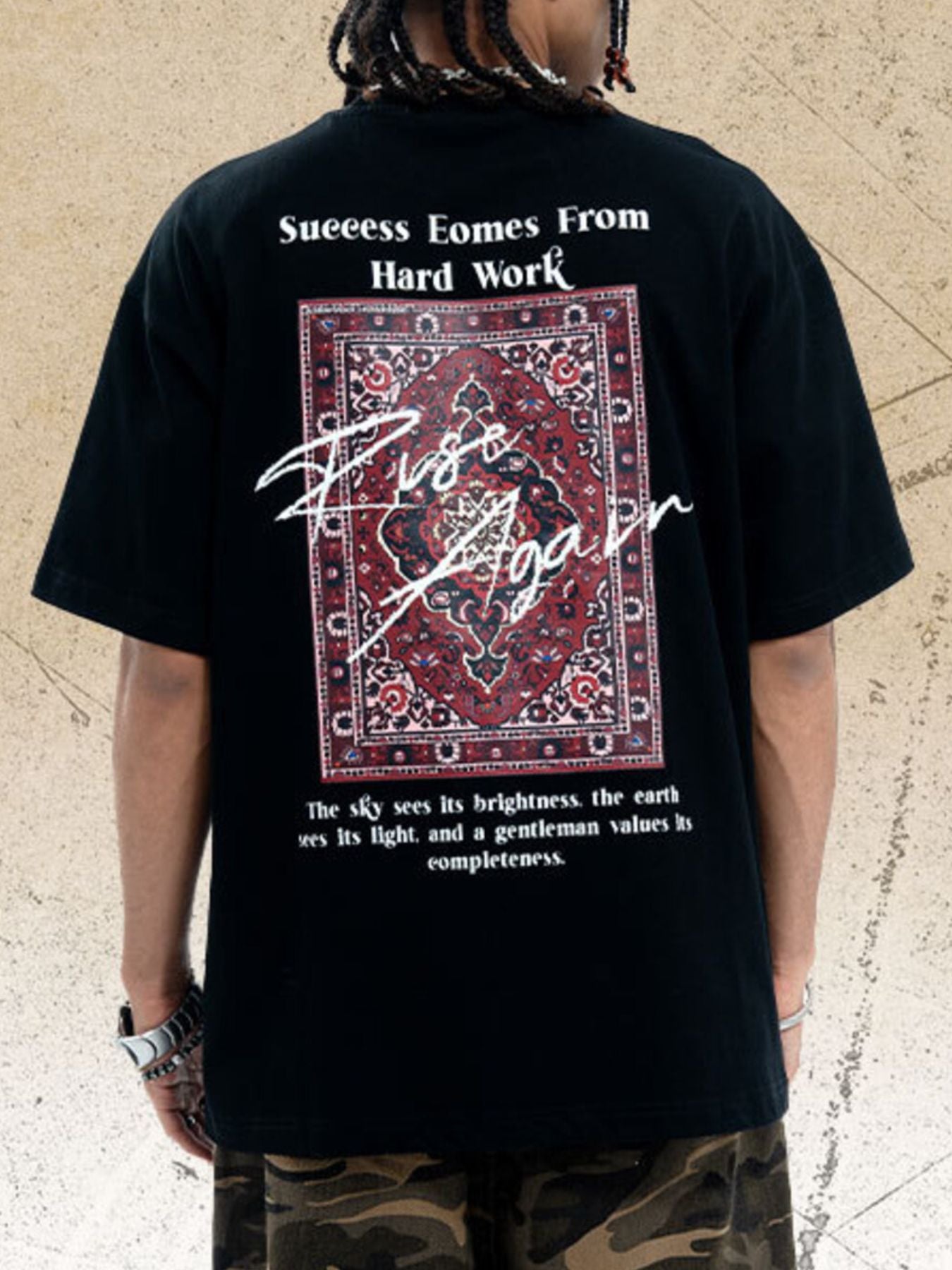 Black cotton crew neck t-shirt with oversized fit and graphic rug print with text.