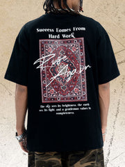 Black cotton crew neck t-shirt with oversized fit and graphic rug print with text.