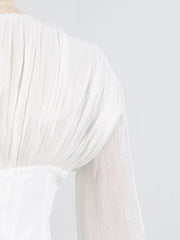 White mini dress with balloon sleeves featuring pleated fabric detail