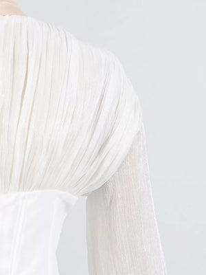 White mini dress with balloon sleeves featuring pleated fabric detail