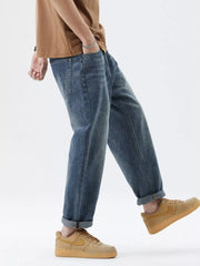Men's blue washed stretch denim jeans with cuffed hems.