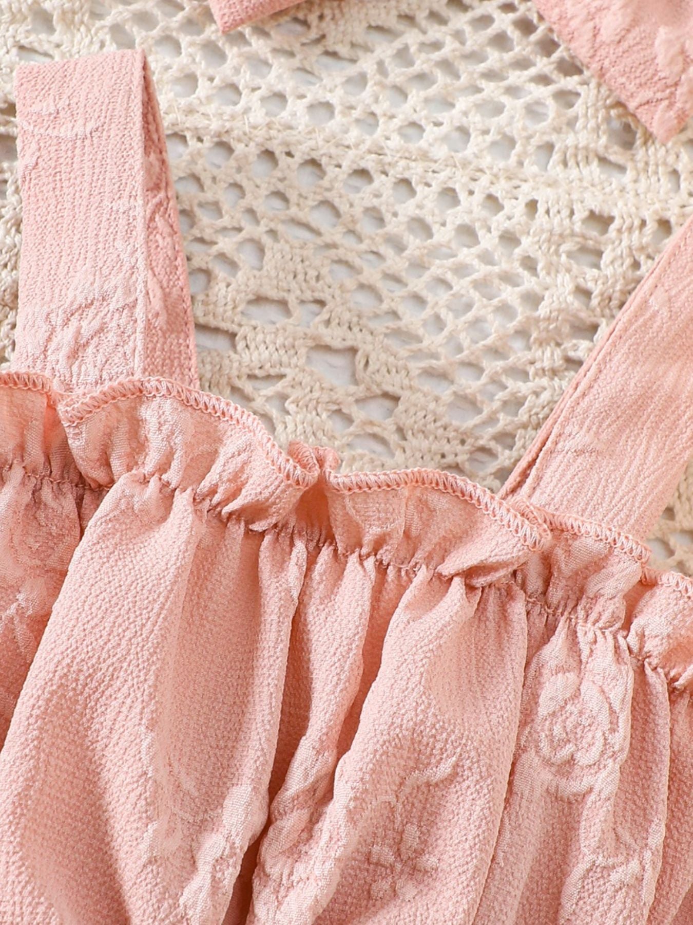 Pink floral embossed baby one-piece with ruffles and headband. Cotton blend.