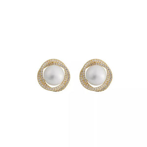 Gold pearl and zircon stud earrings with a twisted halo design.