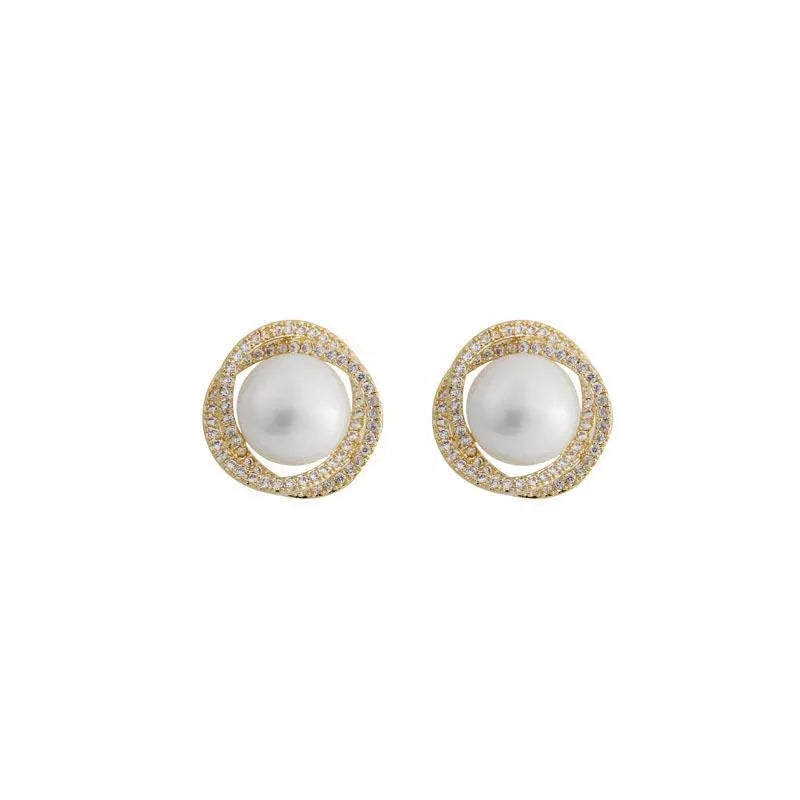 Gold pearl and zircon stud earrings with a twisted halo design.
