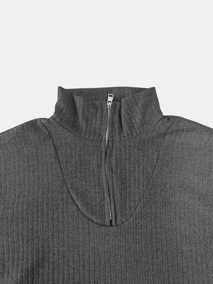 Dark gray ribbed knit quarter-zip pullover sweater with a mock neck.