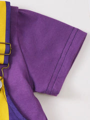 Purple tee with yellow and purple striped overalls, showing strap detail.