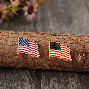 Waving flag enamel pins, one silver-toned and one gold-toned, with butterfly clutches.