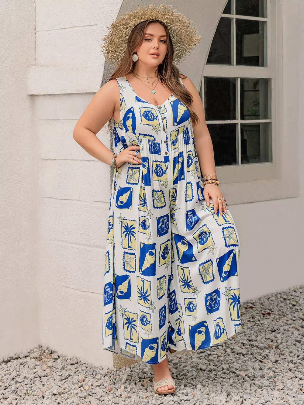 Plus-size relaxed jumpsuit with nautical print, V-neck, button front, and wide legs.