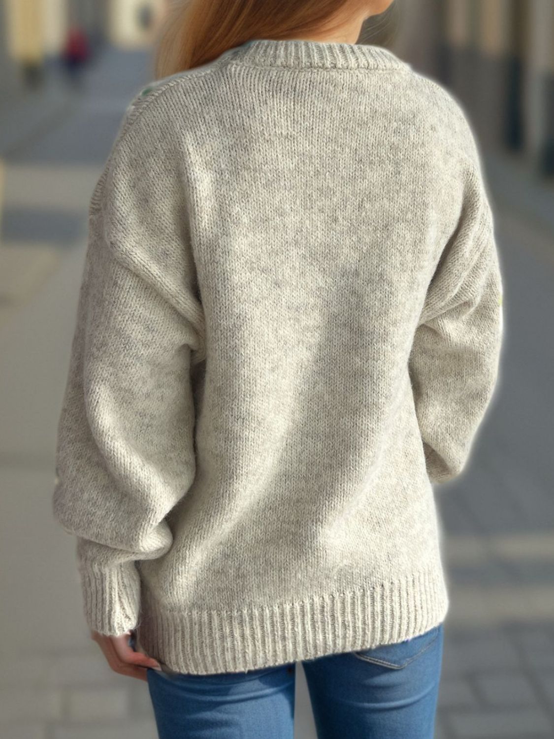 Oversized beige crewneck sweater with textured knit and ribbed cuffs and hem.