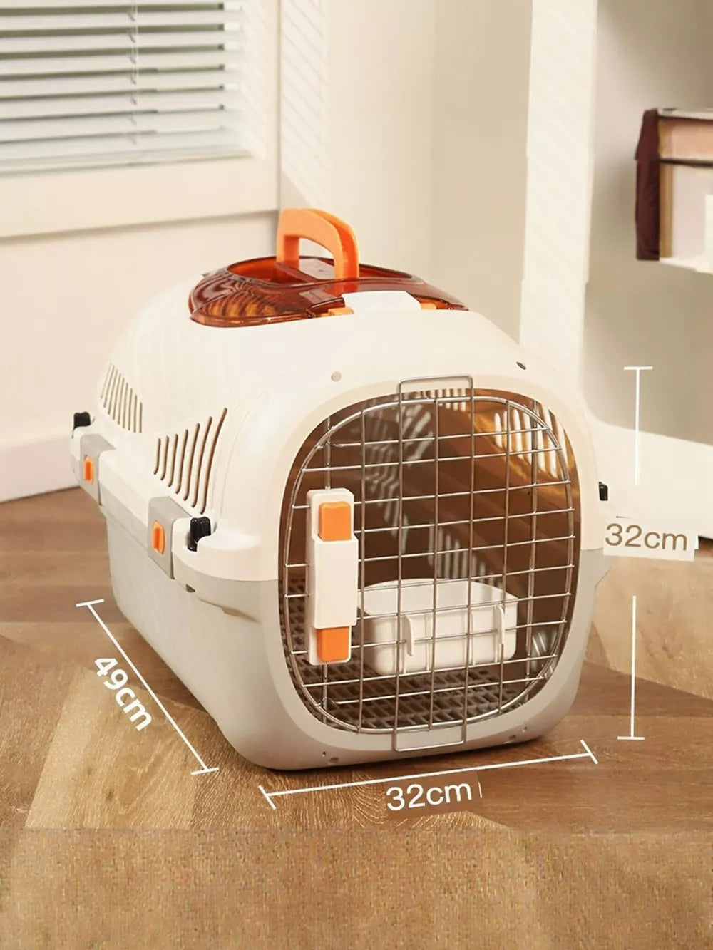 White and gray hard-sided pet carrier with orange accents and a metal door.