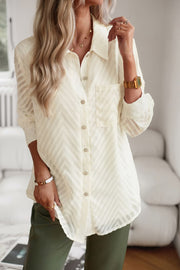 Ivory textured chevron button-down blouse with a single chest pocket and button cuffs.