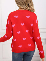 Red acrylic sweater with pink heart print, crew neck, long sleeves, and ribbed trim.