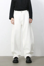 Sculpted white denim balloon trousers with a high waist and wide leg.