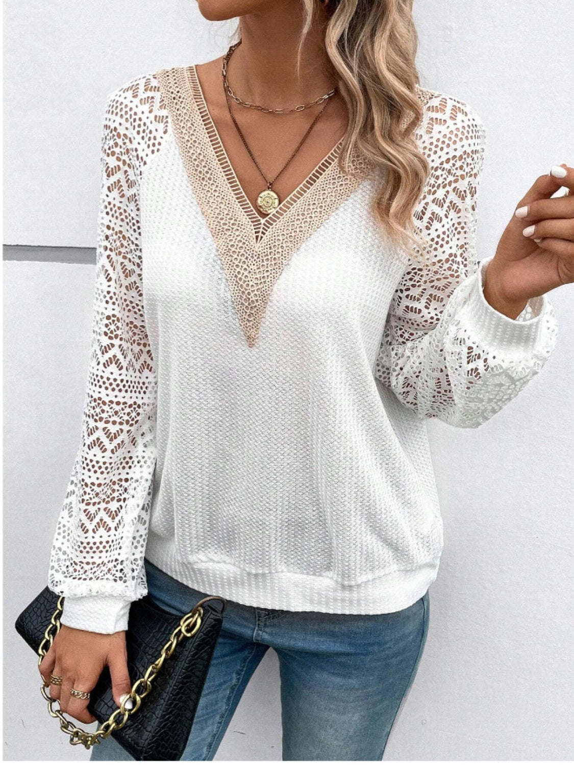 White waffle knit top with lace yoke and sleeves, V-neck, long sleeves.