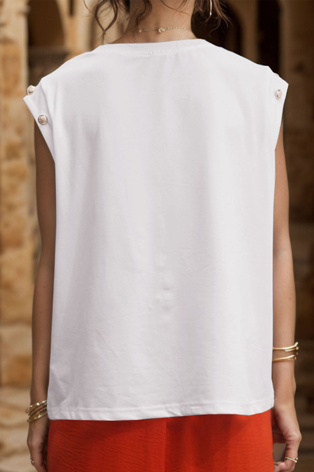 White cap sleeve tee with button detail on shoulder