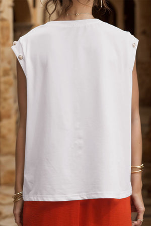 White cap sleeve tee with button detail on shoulder
