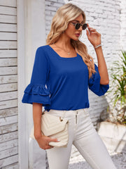 Royal blue blouse with square neckline and ruffled bell sleeves.