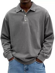 Grey vintage washed long sleeve men's cotton polo shirt with buttoned placket.