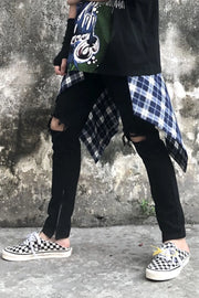 Black skinny fit jeans with distressed knees and ankle zippers.