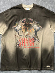 Distressed khaki t-shirt with a bold shark graphic and distressed details.