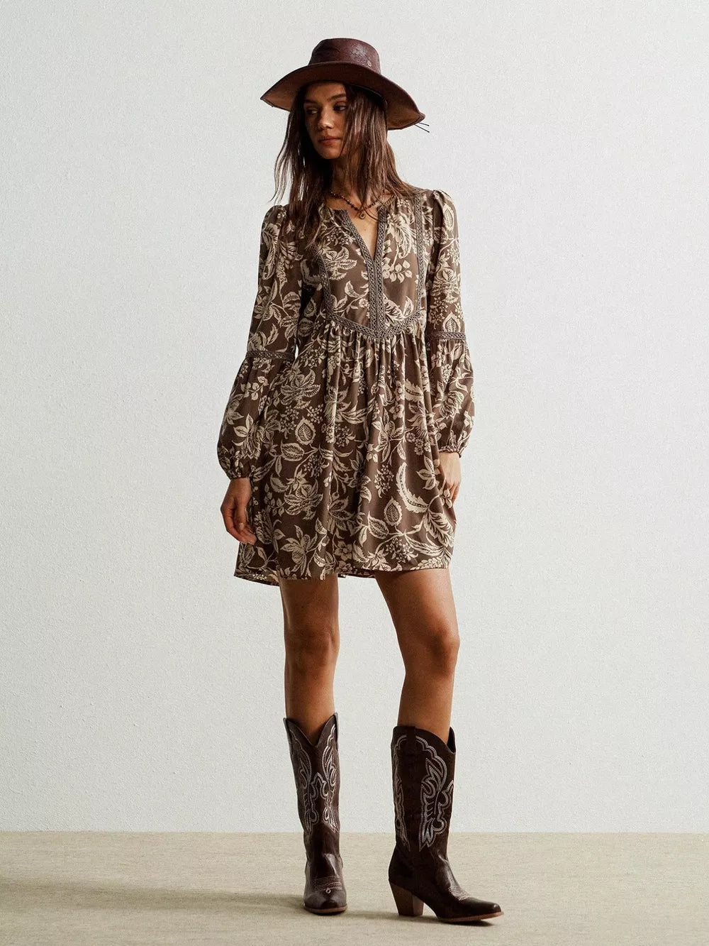 Brown floral print dress with balloon sleeves and a notched neckline.