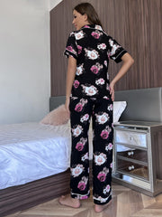 Floral print pajama set with contrast trim, featuring short sleeves and buttoned top.