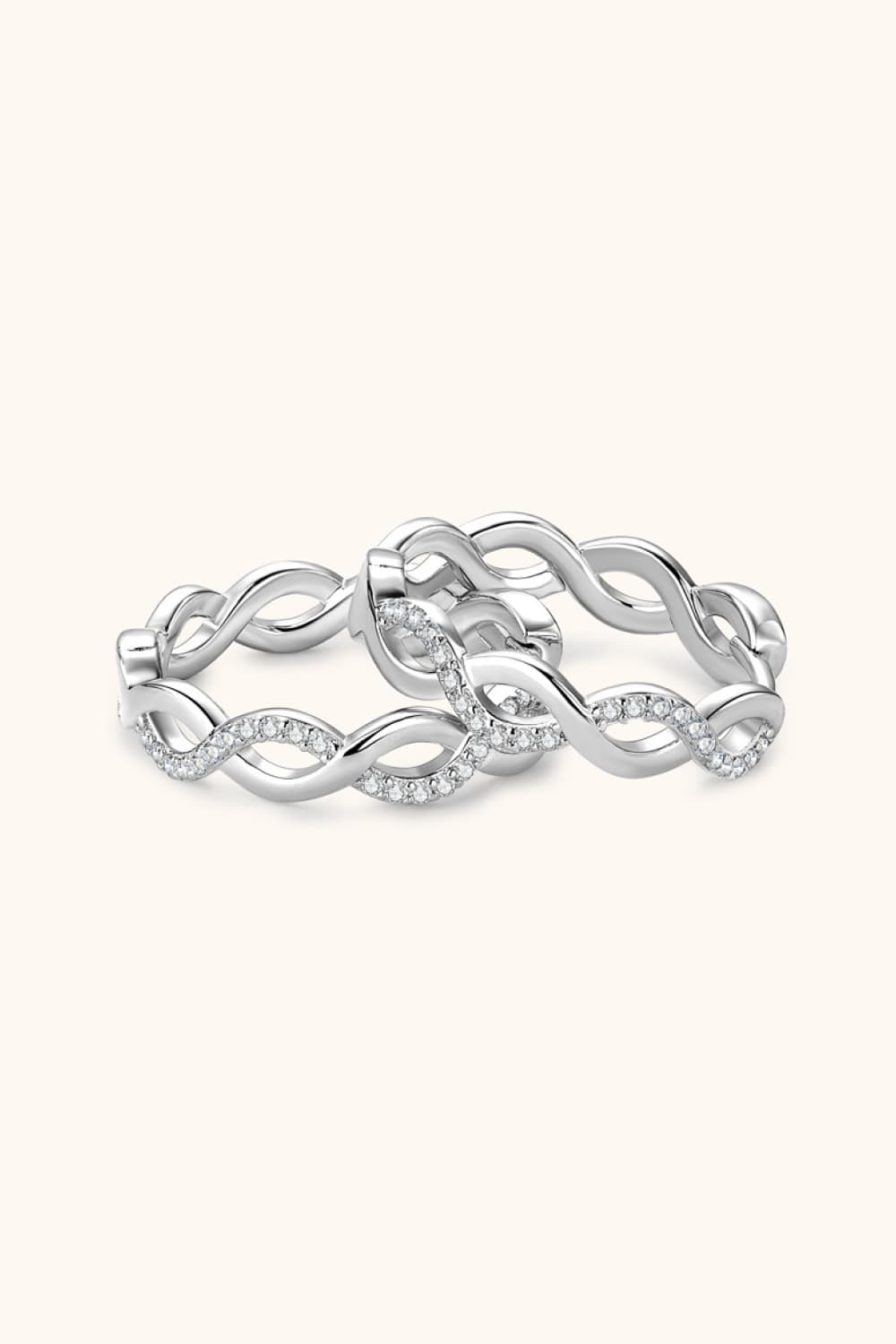 Silver braided pavé hoop earrings with a twisted infinity design.