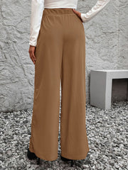 Belted palazzo trousers in caramel polyester with a fluid drape, wide leg.