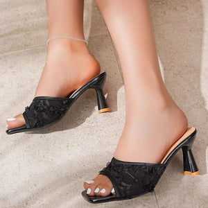 Black lace open-toe mules with flared heel and square toe