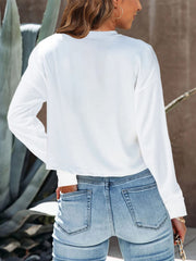 White cropped crewneck long sleeve top with relaxed fit
