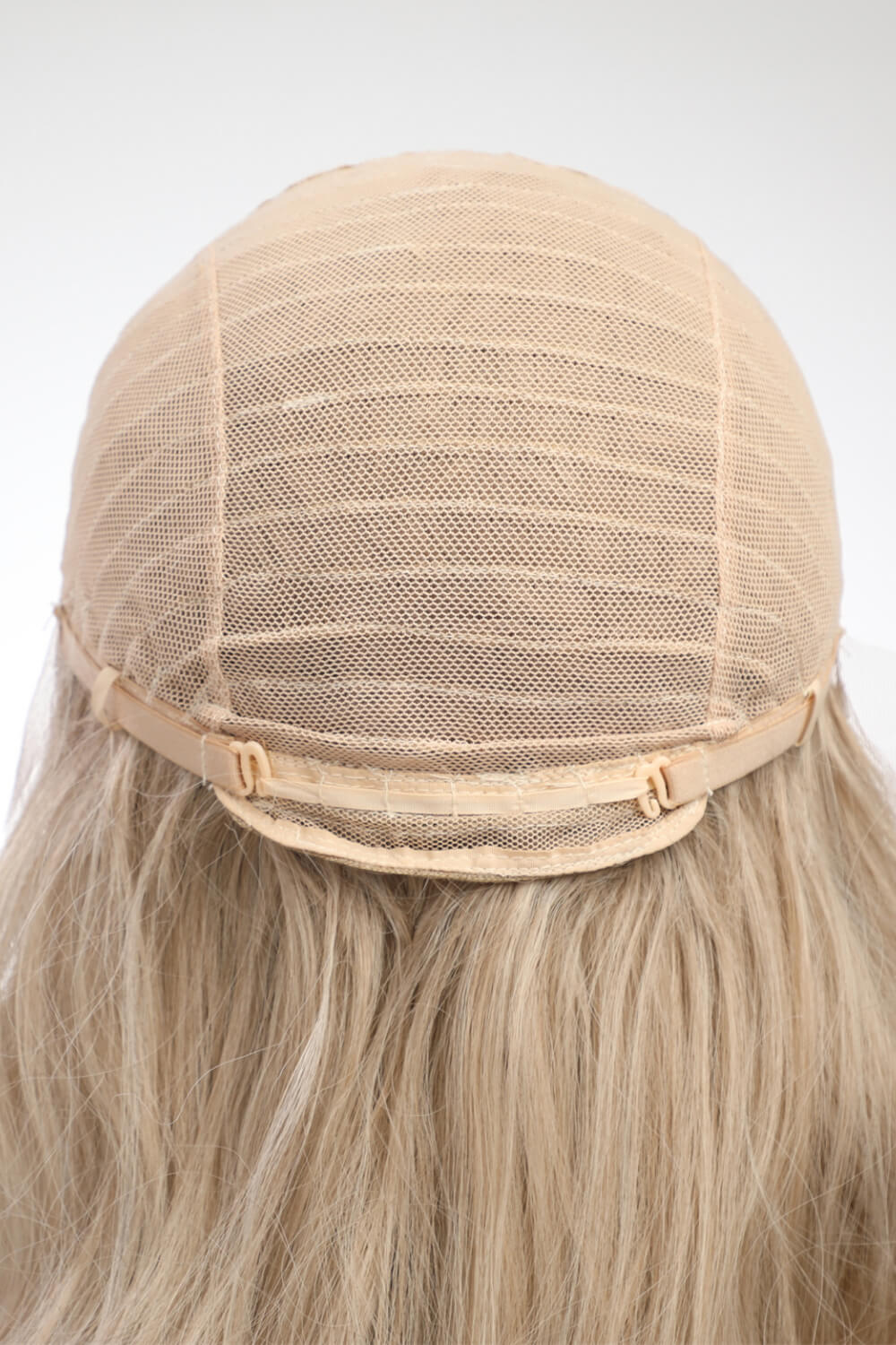Blonde lace front wig cap construction with adjustable straps and blonde wavy hair
