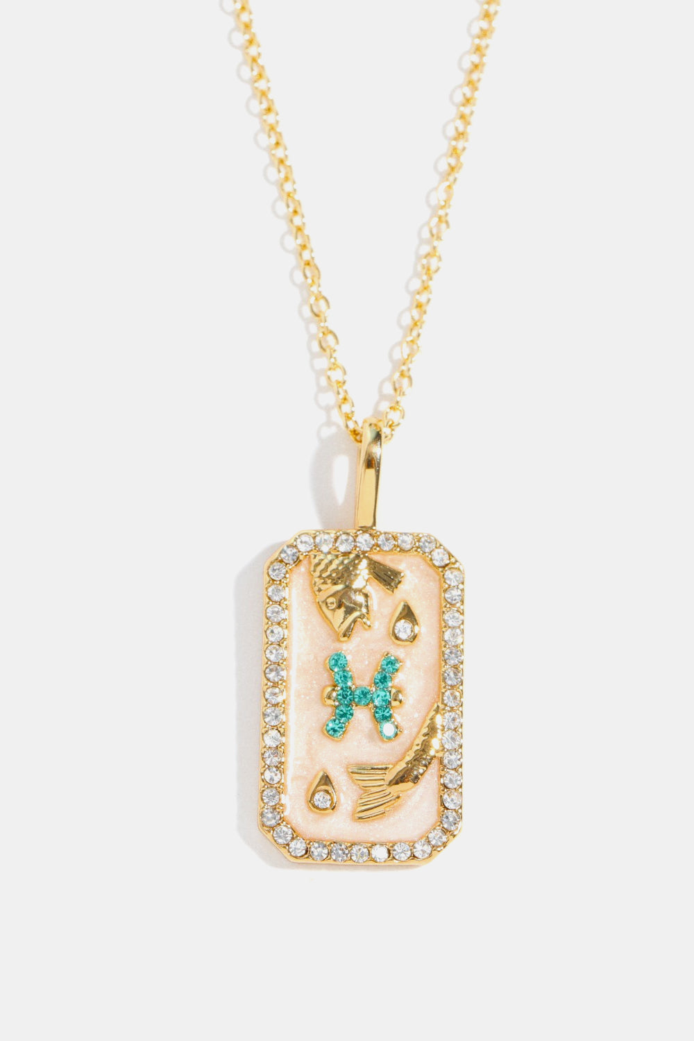Pisces zodiac sign crystal pendant necklace, 14K gold-plated with rhinestones and turquoise accents.