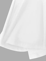 White ruffle hem dress detail showing layered fabric and hemline.