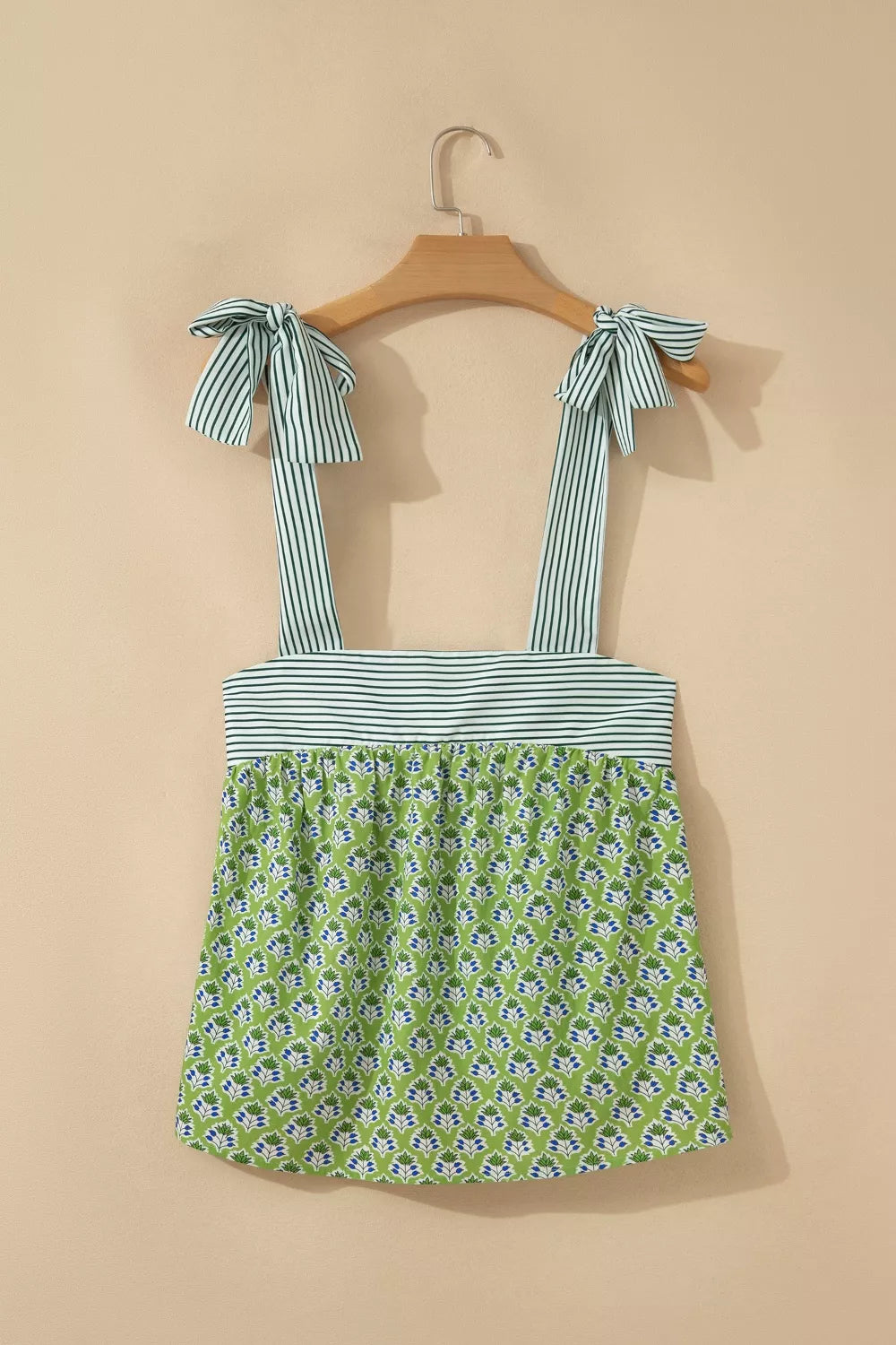 Floral tie-strap tank top with square neckline and green floral print.