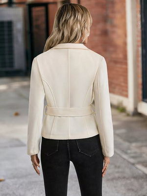 Belted button-up trench coat in beige with a cinched waist and tailored fit.