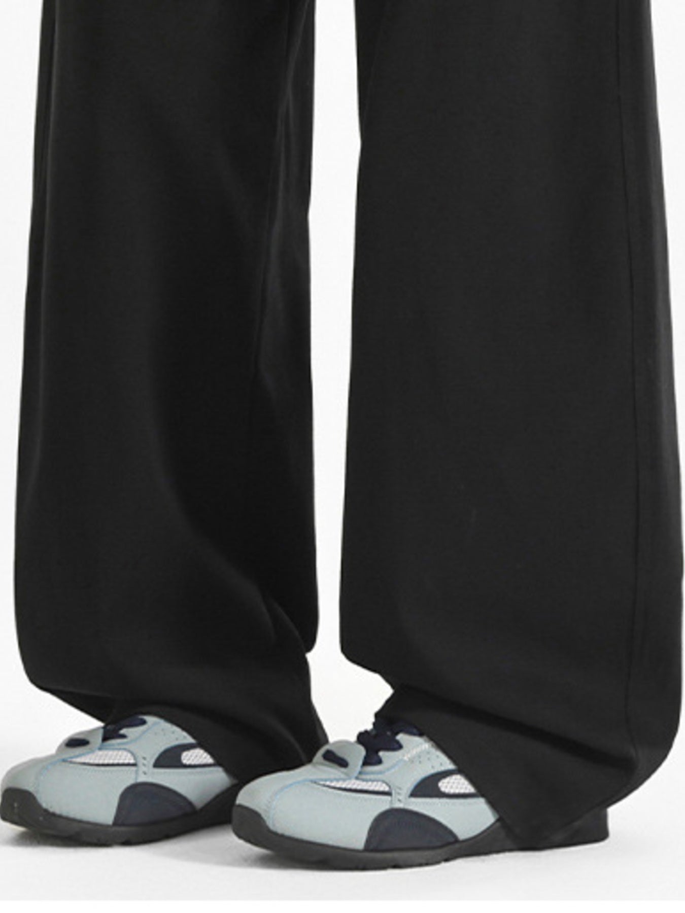 Black wide-leg casual pants shown with light grey sneakers.