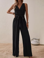 Black V-neck tie-waist wide-leg romper with sleeveless design and textured fabric.