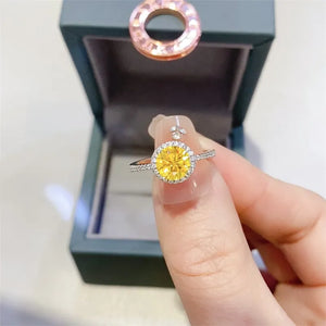 Halo-set canary diamond ring in silver with pave band and small diamond accents.