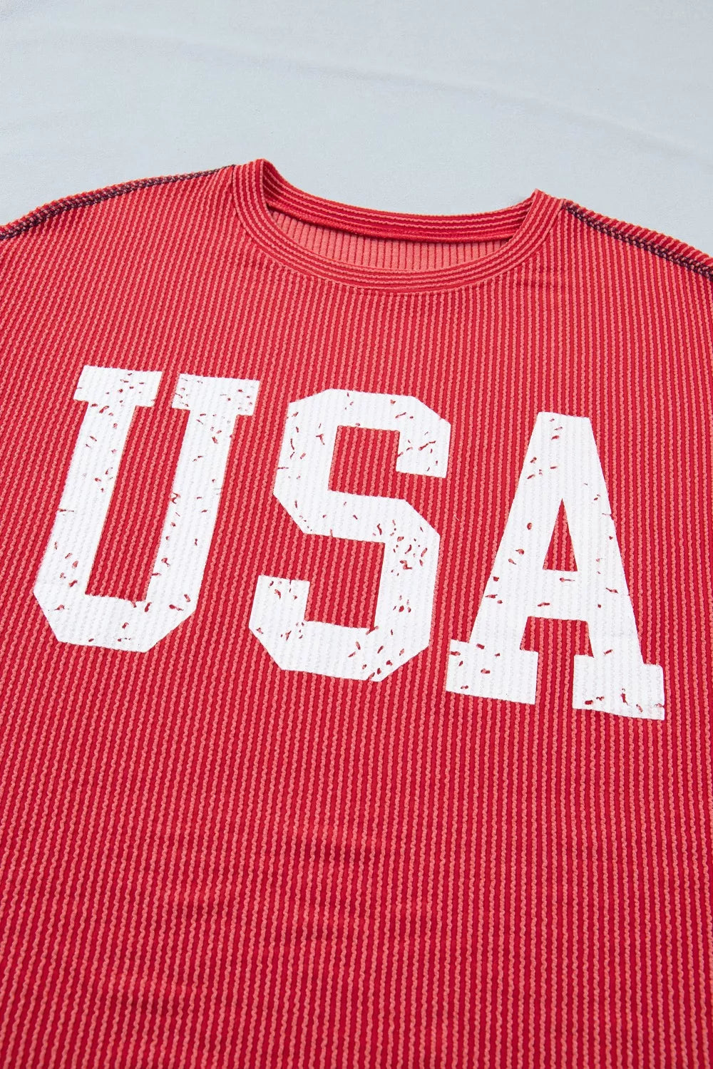Red twisted rib t-shirt with distressed white USA graphic and crew neck.