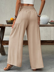 Smocked waist wide leg cotton pants in beige with a relaxed fit.