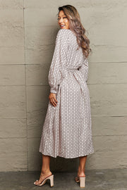Beige geometric print midi dress with belt and long sleeves.
