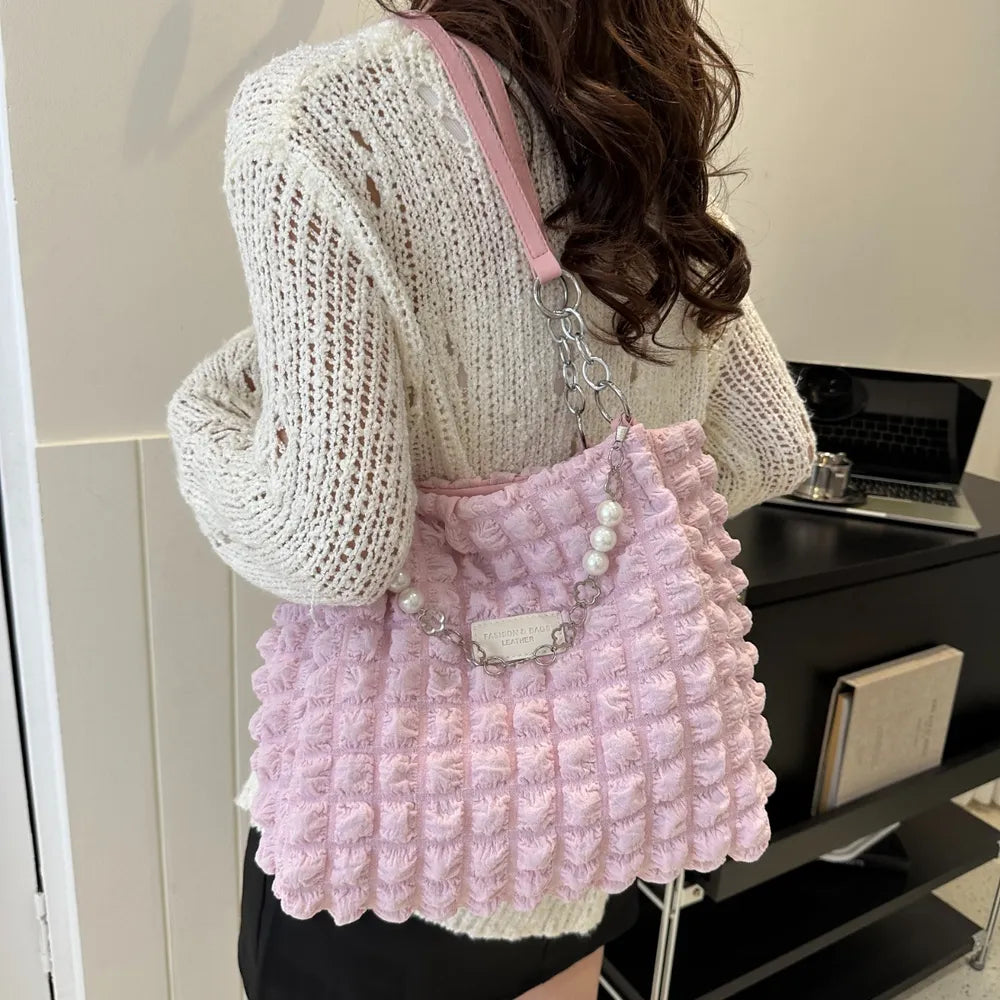 Blush pink textured grid shopper bag with pearl chain detail and silver hardware.